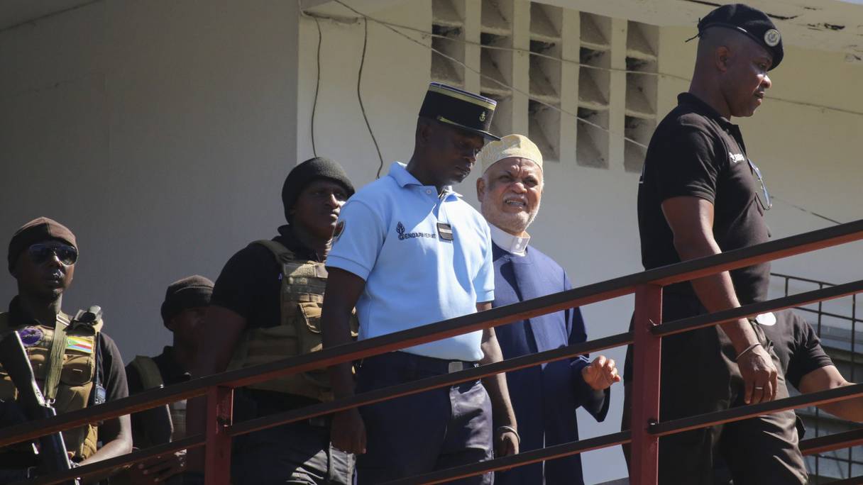 L'ancien président comorien Ahmed Abdallah Sambi (2e R), escorté par des gendarmes, arrive au palais de justice de Moroni le 21 novembre 2022. - Sambi, qui a été président de 2006 à 2011, principal opposant à l'actuel dirigeant Azali Assoumani, est en résidence surveillée depuis mai 2018.