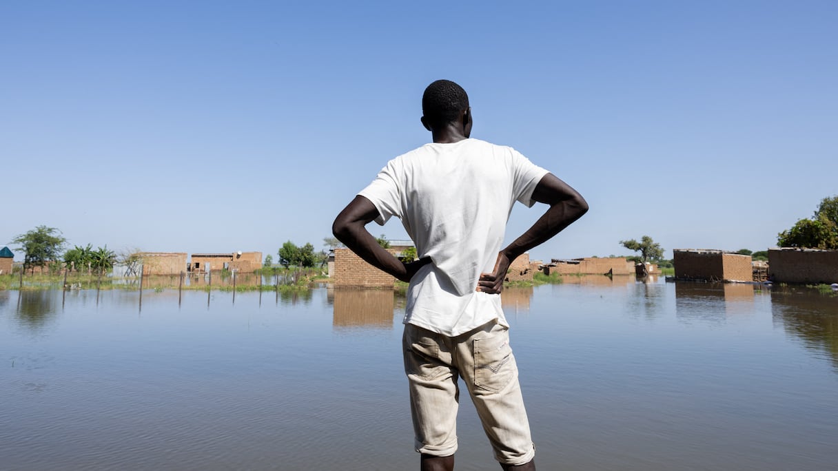 Un homme face aux eaux de crue du fleuve Logone dans le quartier de Tougoude, au sud-est du neuvième arrondissement de Ndjamena, le 8 octobre 2024.