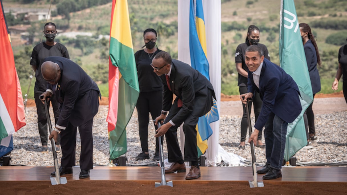 Akufo-Addo président du Ghana (L), Paul Kagame (2e L) président du Rwanda, Ugur Sahin PDG de BioNtech (R) innovent pour marquer le début de la construction de la première usine africaine de vaccins à ARNm dans la zone économique de Kigali, Kigali, Rwanda, le 23 juin 2022. Selon BioNTech, cette usine permettra aux pays africains de lancer leur propre réseau de fabrication de vaccins. (Photo de Simon Wohlfahrt/AFP).
