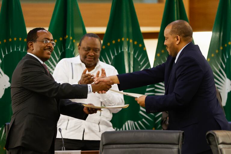 Redwan Hussein (G), représentant du gouvernement éthiopien, et Getachew Reda (R), représentant du Front de libération du peuple du Tigré (TPLF), se serrent la main à un accord de paix entre les deux parties lors d'une conférence de presse concernant les négociations menées par l'Union africaine pour résoudre le conflit en Éthiopie dans les bureaux du Département des relations internationales et de la coopération (DIRCO) à Pretoria le 2 novembre 2022.